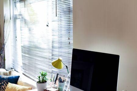 Home working area with office desk set up in living roomの写真素材