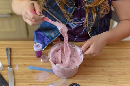 Kids have fun learning at home making slime in a creative science experimentの写真素材