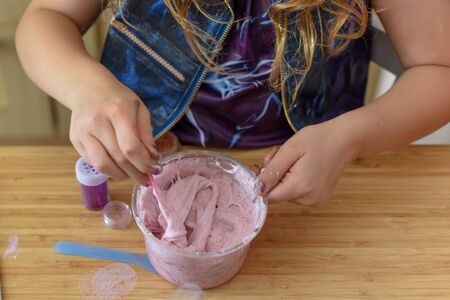Kids have fun learning at home making slime in a creative science experimentの写真素材