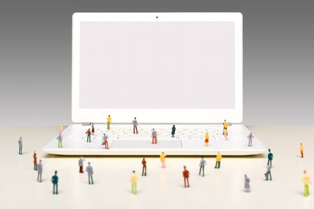 Crowd of people looking at a computer screen waiting for a message or information update on website