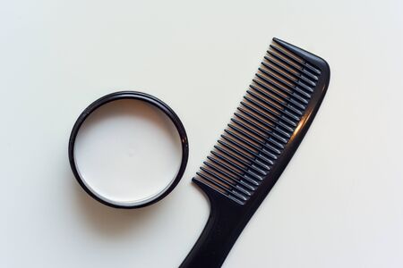 Men's hair product paste with black comb isolated on white backgroundの写真素材