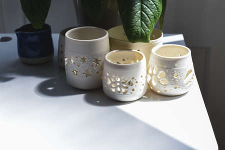 Group of hand made pottery vases and ceramic decorative bowls in room interiorの写真素材