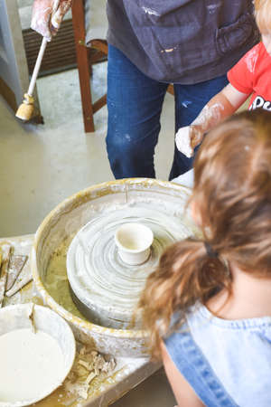 Children making pottery during ceramic lesson with clayの写真素材