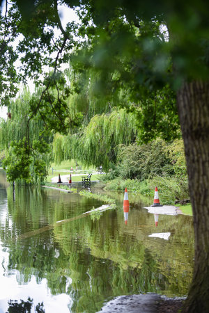 Flood water overflows from a lake during flooding after heavy rain and bad weatherの写真素材
