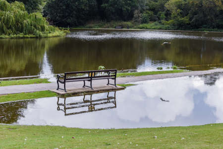 Flood water overflows from a lake during flooding after heavy rain and bad weatherの写真素材