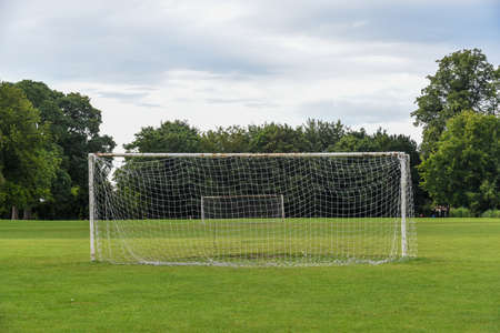 Outdoor football pitch with goals and soccer nets in public parkの写真素材
