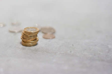 New pound coins from english sterling currency in a pileの写真素材