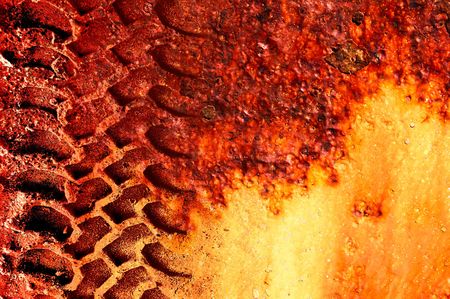 Life on Mars. Grungey tyre on track on red 'Martian' background.