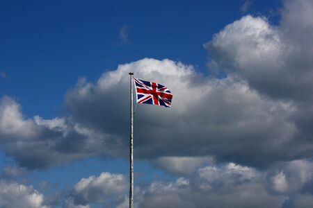 Union Flag on a windy day. This is the flag, generally regarded, to represent the peoples of England, Scotland, Wales and Northern Ireland. The image may show the effect of the wind at full size.の写真素材