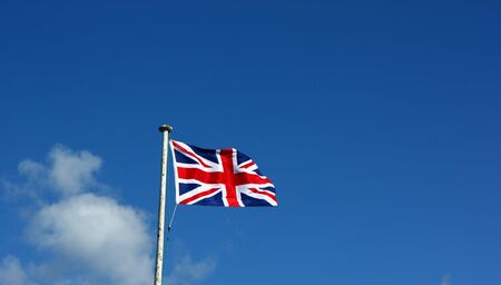 Union Flag on a windy day. This is the flag, generally regarded, to represent the peoples of England, Scotland, Wales and Northern Ireland. The image may show the effect of the wind at full size.の写真素材