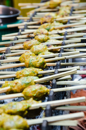 Thai meat chicken ball with herbs on grillの写真素材