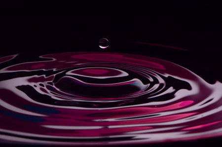 Ripples In Purple Water With Dropletの写真素材
