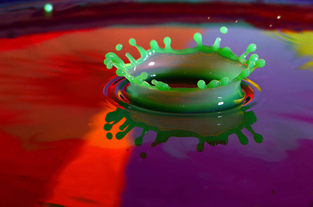 Green Water Splash With Purple and Red Background