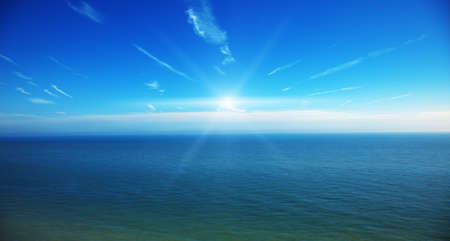 Sun shines above the ocean の写真素材
