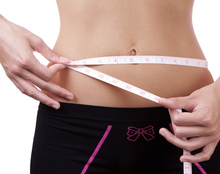 Detail of a woman measuring waistの写真素材