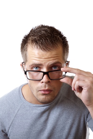 Man adjusting his glasses to get a better viewの写真素材