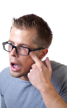 Man suffers from pain in eye because of wearing glassesの写真素材