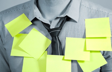 Businessman with plenty of post it notesの写真素材