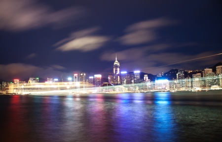 Cruise ship passing Victoria harbour at night in Hong Kongの写真素材