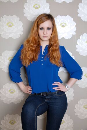 Portrait of a casual woman with curly red hairの写真素材