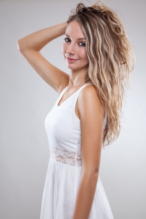 Beautiful young woman wearing a white dressの写真素材