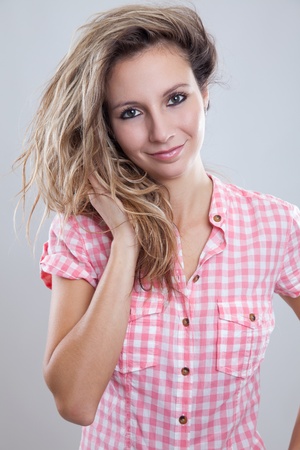 Good looking young woman holding her hairの写真素材