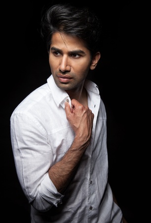 Portrait of an Indian man on black background