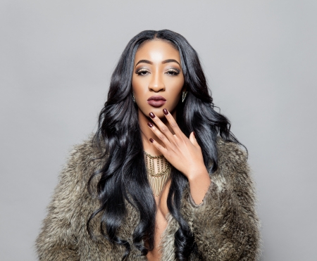 Young black beautiful woman with elegant curly hairの写真素材