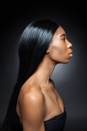 Beautiful young black woman with long straight hairの写真素材