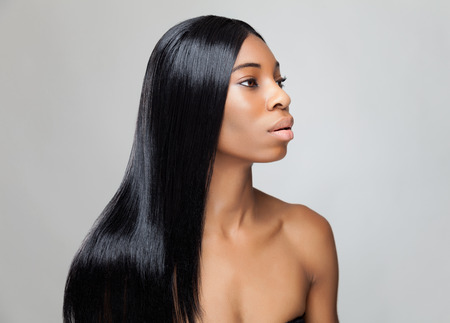 Beautiful young black woman with long straight hairの写真素材