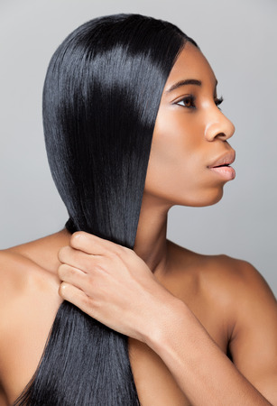 Beautiful young black woman with long straight hairの写真素材