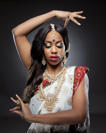 Young Indian woman dressed in traditional clothing with bridal makeup and jewelryの写真素材