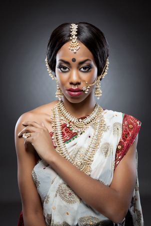 Young Indian woman dressed in traditional clothing with bridal makeup and jewelryの写真素材