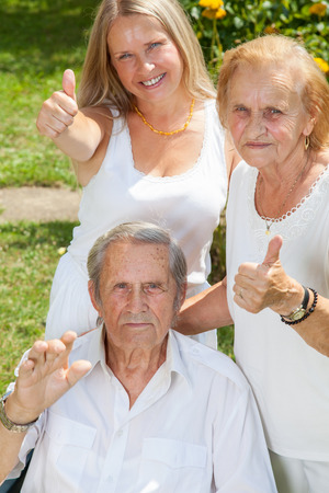 Elderly couple and their daughter outdoorsの写真素材