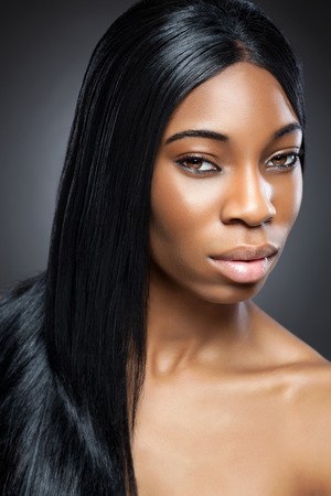 Black beautiful woman with long straight hairの写真素材