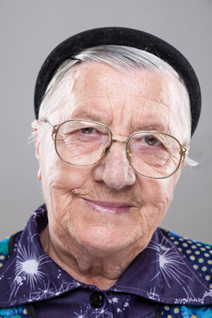 Closeup portrait of an elderly woman with glassesの写真素材