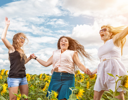 Group of friends having fun outdoors in a fieldの写真素材