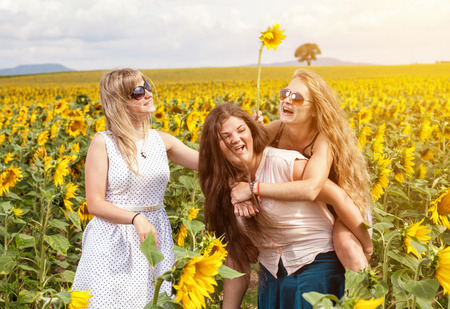 Group of friends having fun outdoors in a fieldの写真素材
