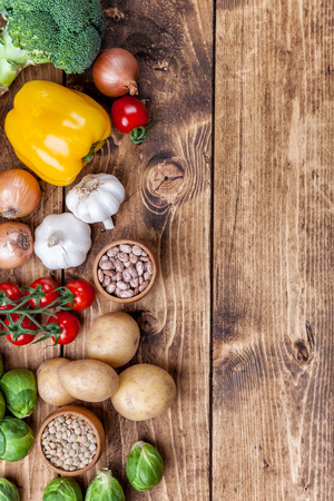 Fresh and healthy organic vegetables and food ingredients on wooden backgroundの写真素材