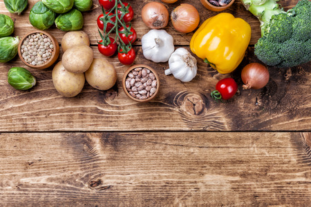 Fresh and healthy organic vegetables and food ingredients on wooden backgroundの写真素材