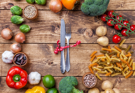 Fresh and healthy organic vegetables and food ingredients on wooden backgroundの写真素材