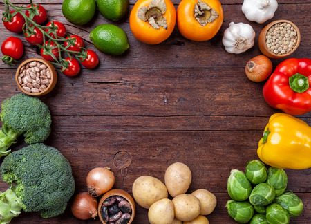 Fresh and healthy organic vegetables and food ingredients on wooden backgroundの写真素材