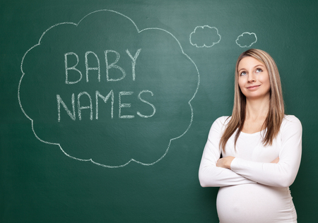 Pregnant woman trying to choose a name for her babyの写真素材