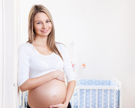 Young and happy pregnant woman expecting a babyの写真素材