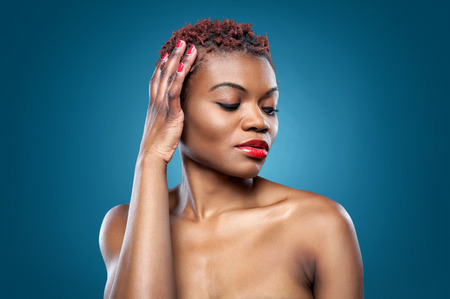 Black beautiful woman with short spiky red hairの写真素材