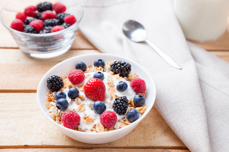 Healthy and nutritious bio yogurt with cereal and fresh raw berries