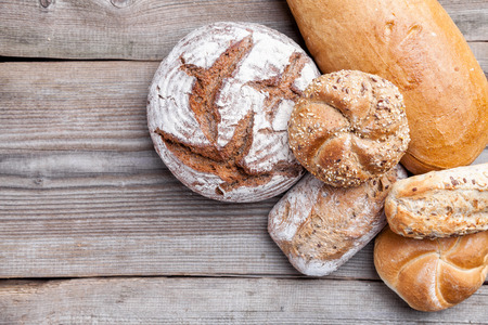 Delicious freshly baked bread on wooden background