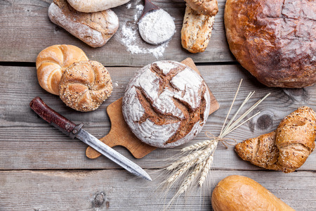 Delicious freshly baked bread on wooden backgroundの写真素材