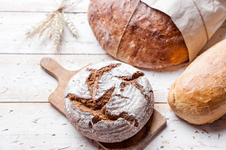 Delicious freshly baked bread on wooden backgroundの写真素材