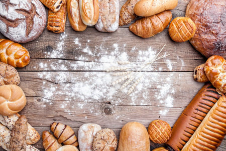 Delicious freshly baked bread on wooden backgroundの写真素材